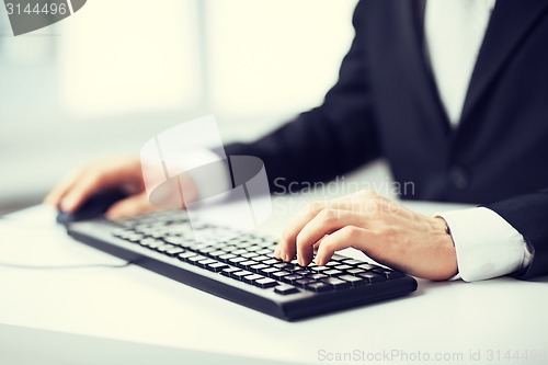 Image of man hands typing on keyboard
