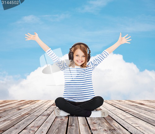 Image of happy girl with headphones listening to music