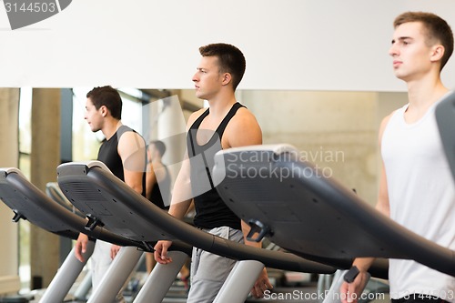 Image of group of men exercising on treadmill in gym
