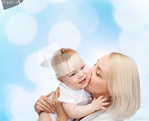 Image of happy mother kissing smiling baby