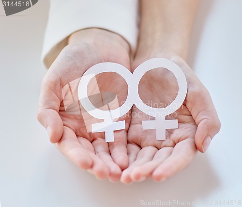 Image of close up of happy lesbian couple with venus symbol