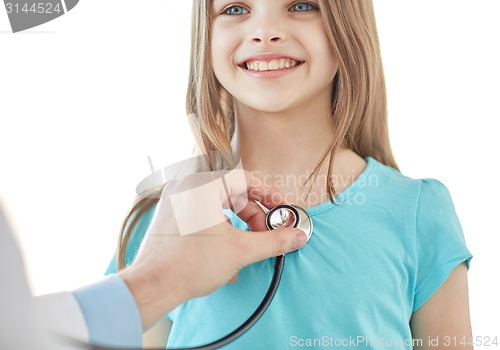 Image of close up of happy girl and doctor on medical exam