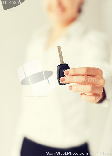 Image of woman hand holding car key