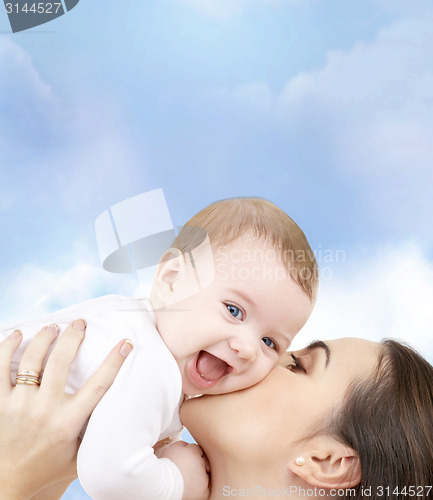 Image of laughing baby playing with mother