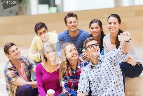 Image of group of students with smartphone and coffee cup