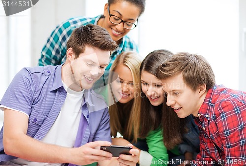 Image of students looking at smartphone at school