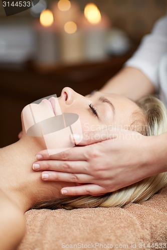 Image of close up of woman having face massage in spa