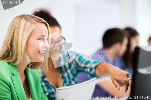 Image of students with computer studying at school