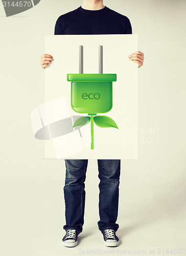 Image of hands holding picture of green electrica ecol plug