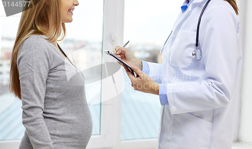 Image of close up of happy pregnant woman and doctor