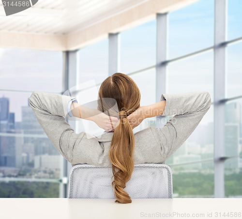 Image of businesswoman sitting on chair from back