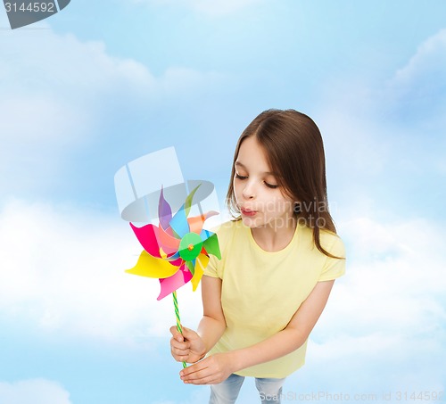 Image of smiling child with colorful windmill toy