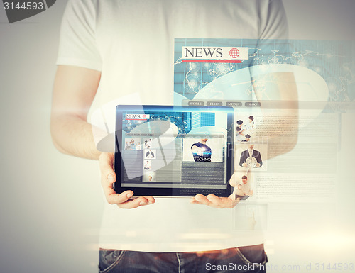 Image of man showing tablet pc with news