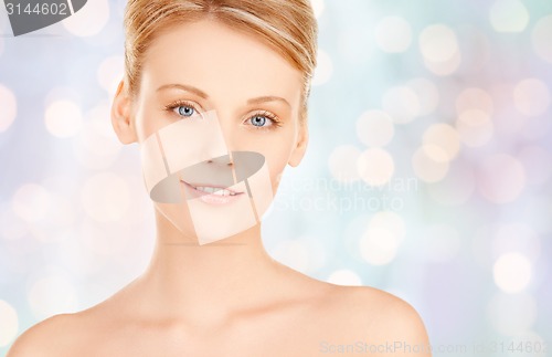 Image of beautiful young woman face over blue background