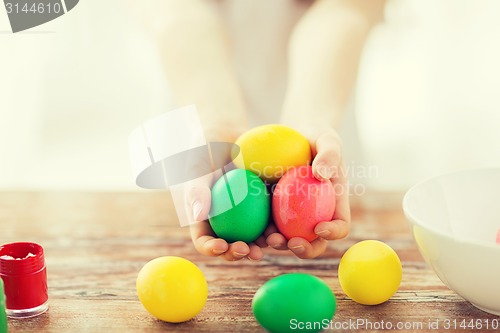 Image of close up of girl holding colored eggs