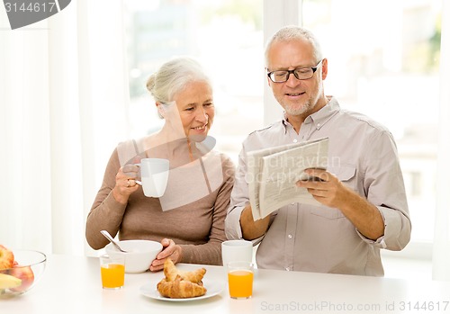 Image of happy senior couple having breakfast at home