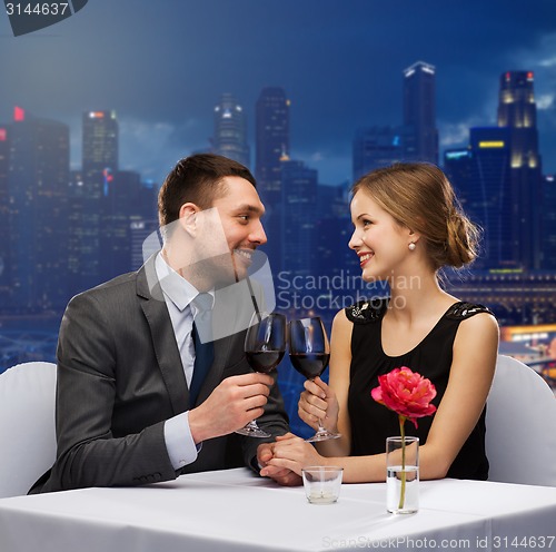 Image of couple with glasses of champagne at restaurant