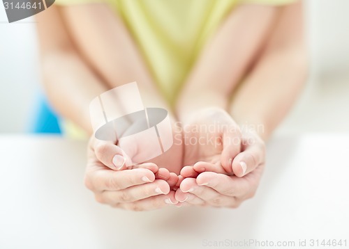 Image of close up of woman and girl with cupped hands