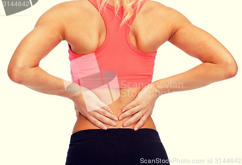 Image of close up of sporty woman touching her back