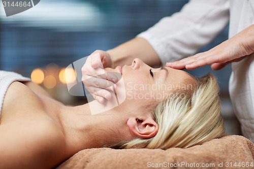 Image of close up of woman having face massage in spa