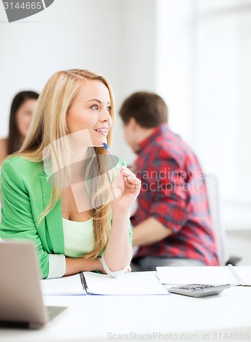 Image of student girl with notebook and calculator