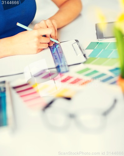 Image of woman working with color samples for selection