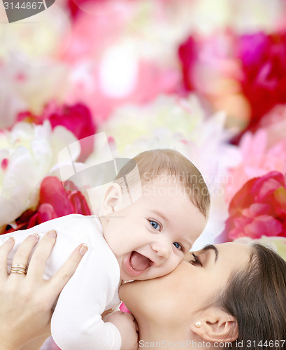 Image of laughing baby playing with mother