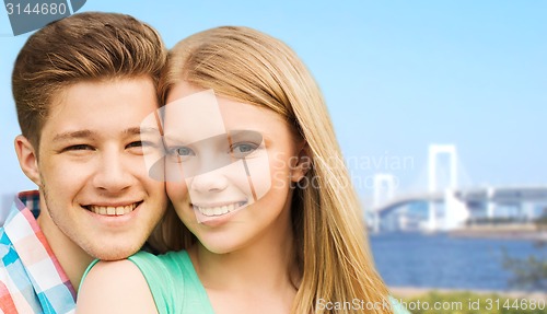 Image of smiling couple over rainbow bridge in tokyo