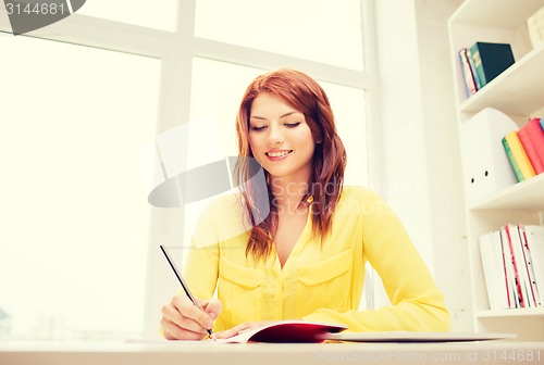 Image of smiling businesswoman or student with tablet pc