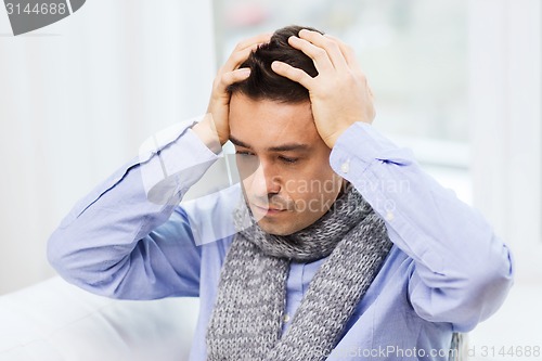 Image of close up of ill man with flu and headache at home