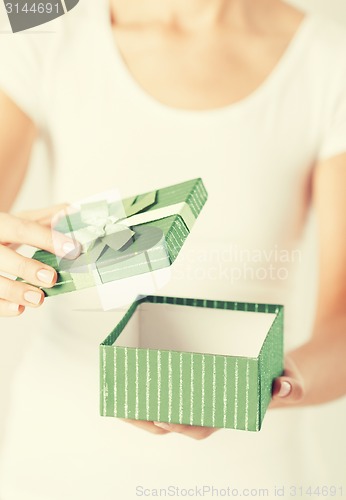 Image of woman hands with gift box