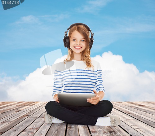 Image of happy girl with headphones and tablet pc
