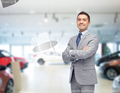 Image of happy man at auto show or car salon