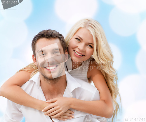 Image of couple having fun over blue lights background