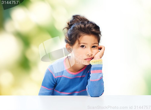 Image of sad little girl over city background