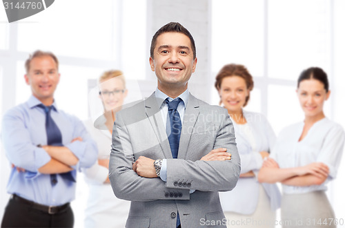 Image of happy smiling business team over office room