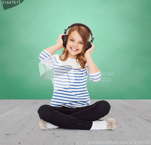 Image of happy girl with headphones listening to music