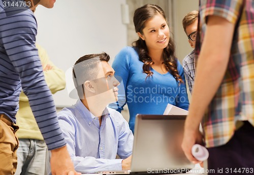 Image of group of students and teacher with laptop