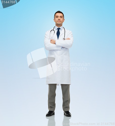 Image of male doctor in white coat over blue background