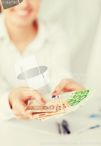 Image of woman hands with euro cash money