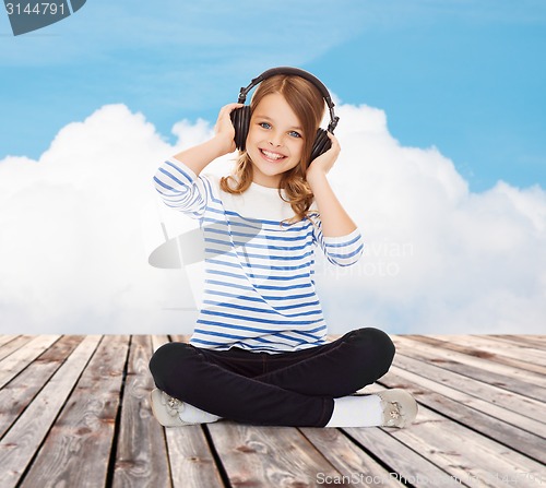 Image of happy girl with headphones listening to music