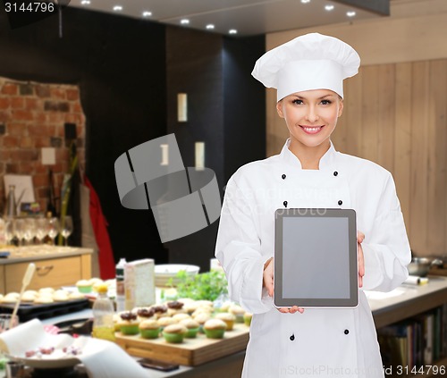 Image of smiling female chef with tablet pc blank screen
