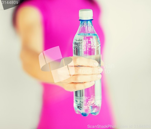 Image of sporty woman with bottle of water