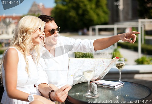 Image of couple with map in cafe