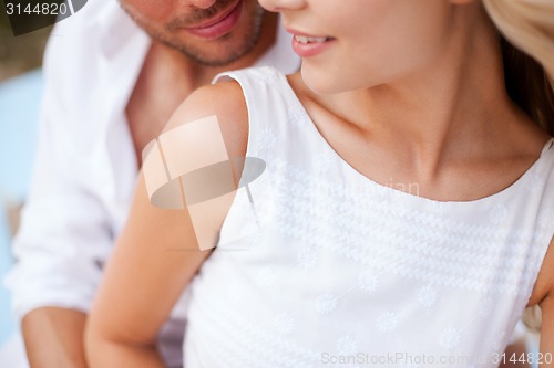 Image of couple in shades at sea side