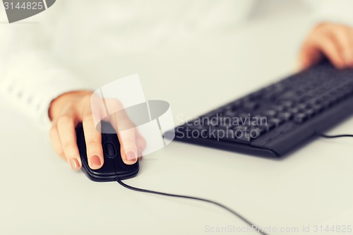 Image of woman hands with keyboard and mouse