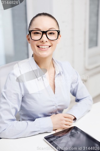 Image of smiling businesswoman in eyeglasses with tablet pc