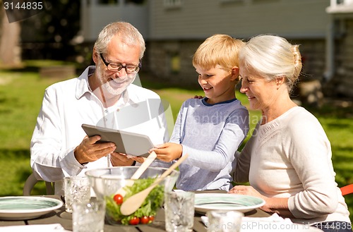 Image of happy family with tablet pc outdoors