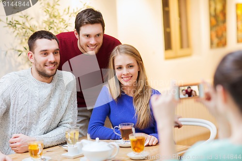 Image of group of friends taking picture with smartphone