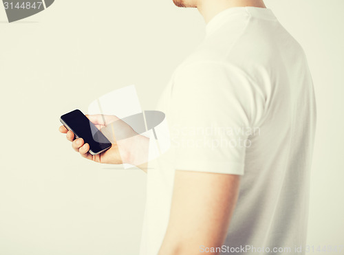 Image of man with smartphone typing something